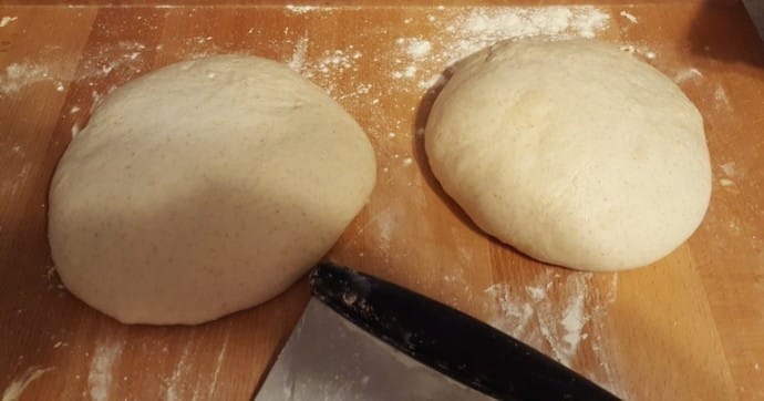 Two pieces of dough in a Taut Ball with a bench knife