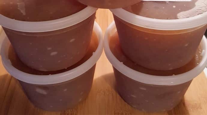 Four round Extreme Freeze Reditainer Freezeable Deli Food Containers with Pressure Cooker Vietnamese Pho Tai in them.