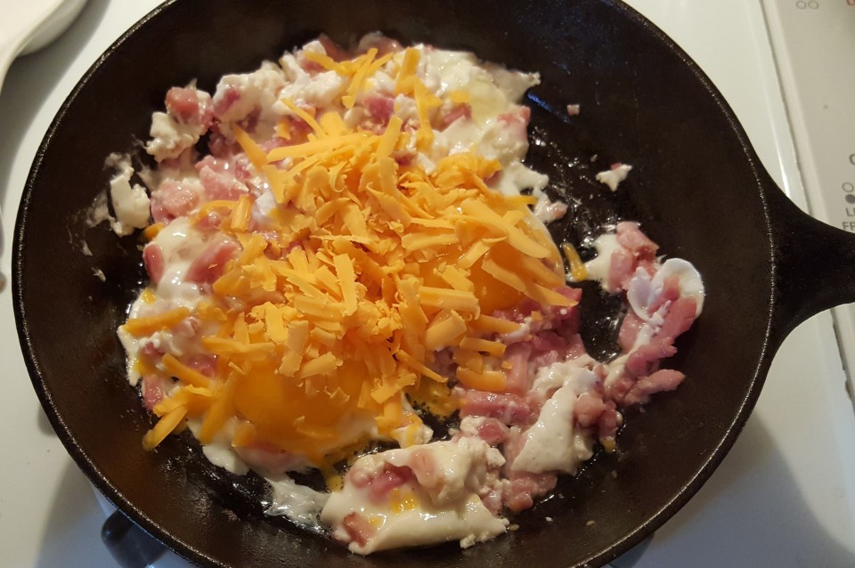 Add Grated Cheese to Cast Iron Pan Over Egg Yolks