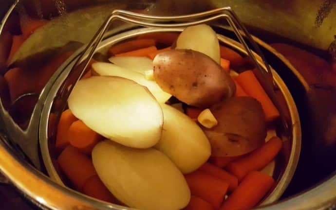 A trivet with potatoes and carrots in the Instant Pot