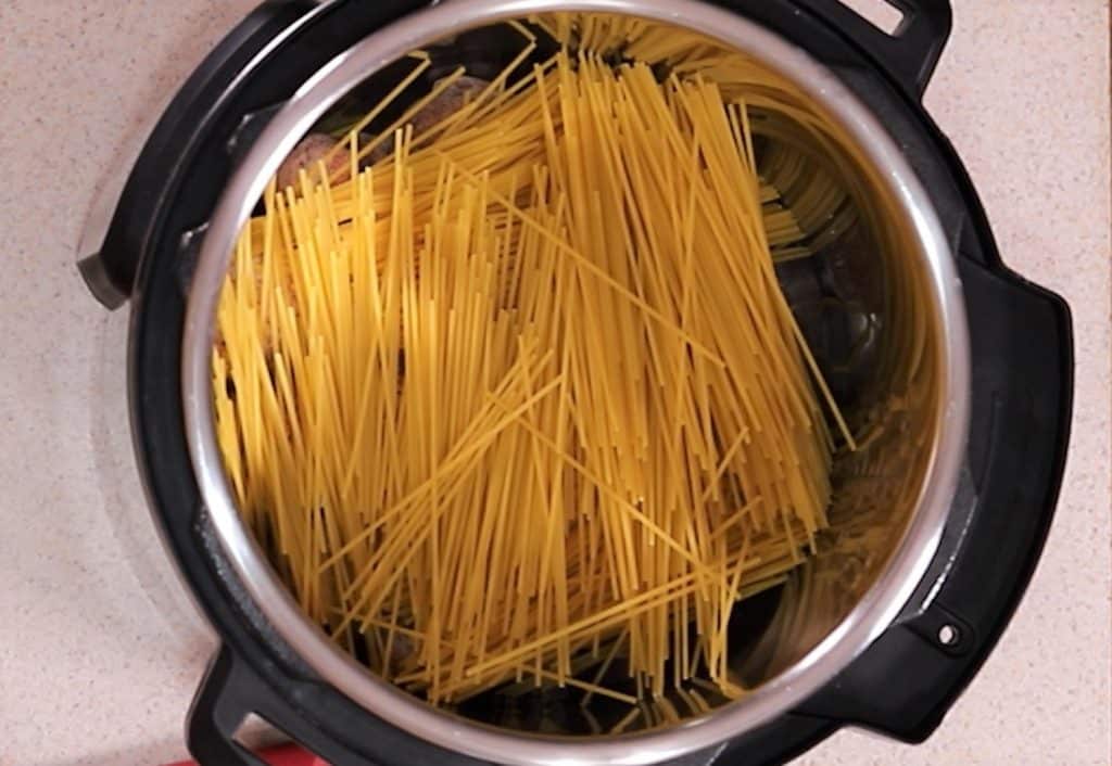 Add Broken Spaghetti to Pot Over Meatballs.