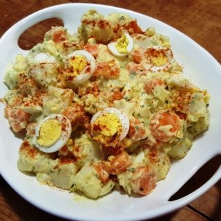 A plate of Instant Pot Potato Salad with Carronts on a table