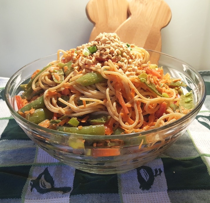 An Asian Noodle Salad bowl with snap peas, carrots, peppers and a peanut butter dressing