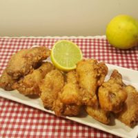 Air Fryer Crispy Old Bay Chicken Wings with a slice of Lemon