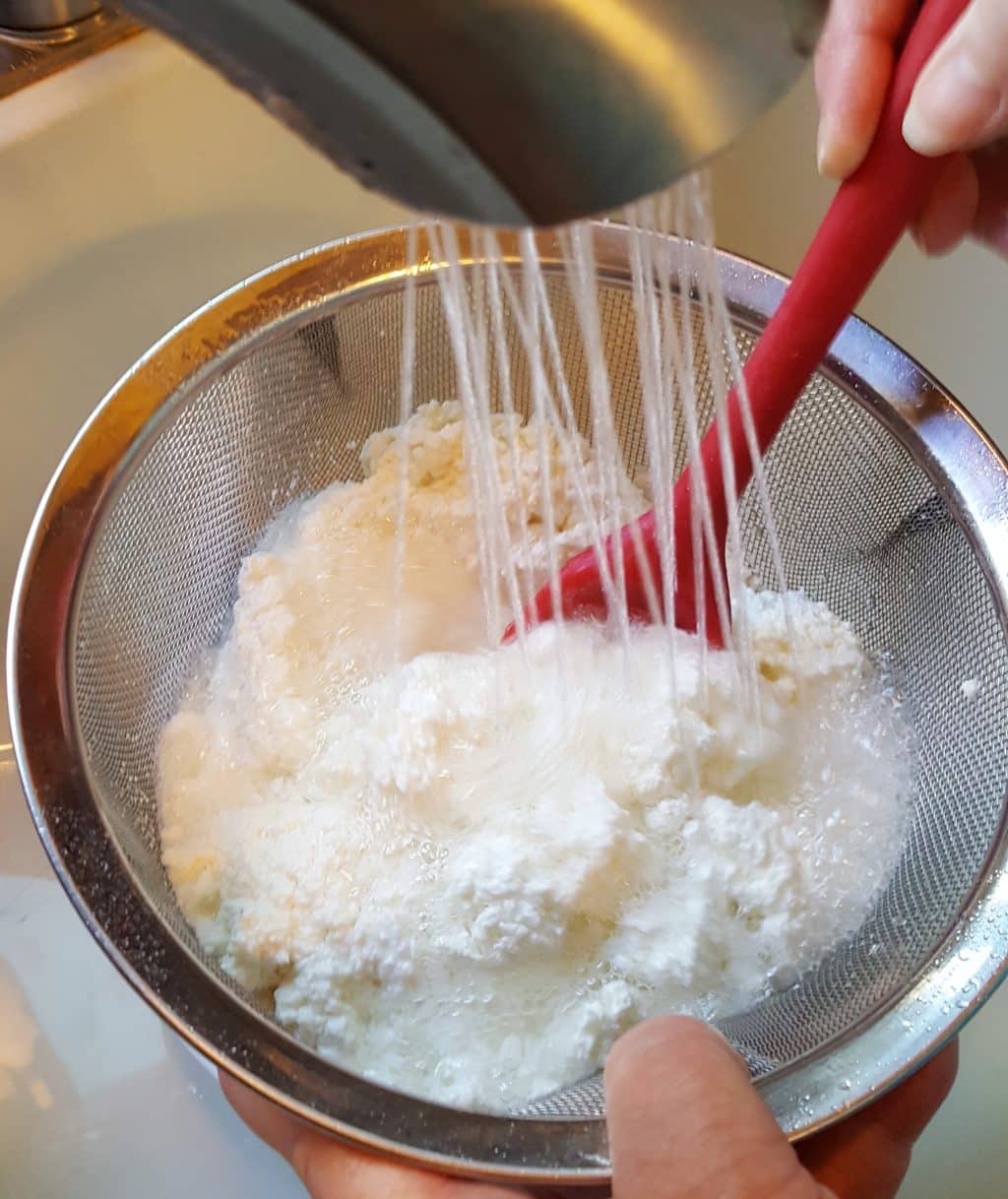 Rinse the Strainer of Cottage Cheese under Cool Water