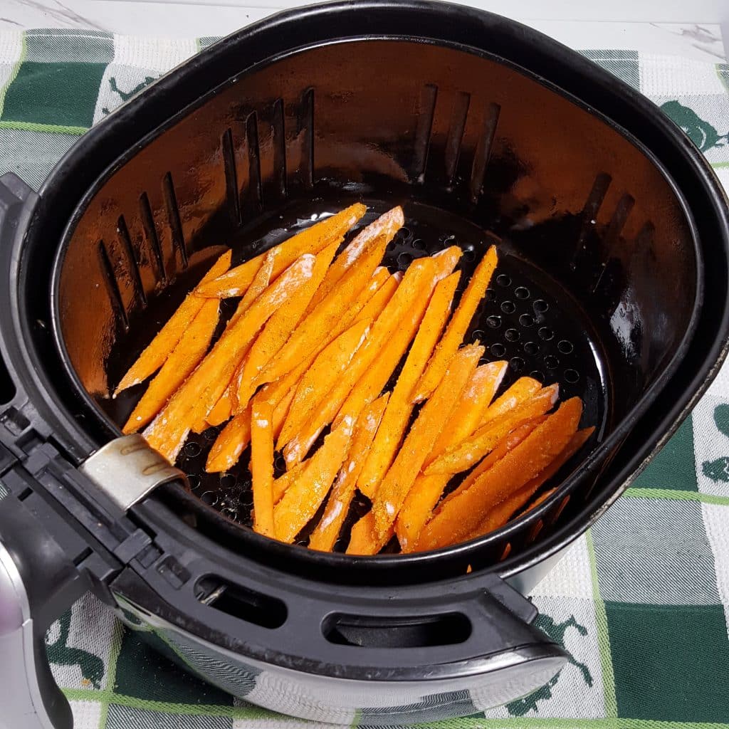 Place Seasoned Sweet Potatoes into Air Fryer