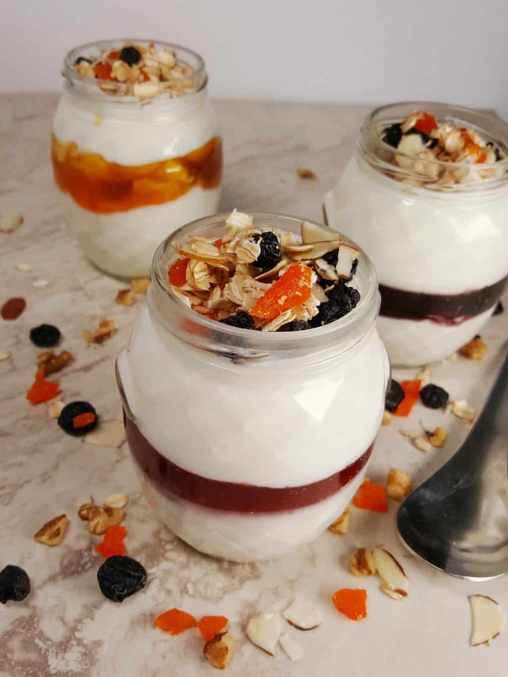 Photo of Instant Pot Cold Start Yogurt with layers of fruit compote and topped with dried fruit and granola.