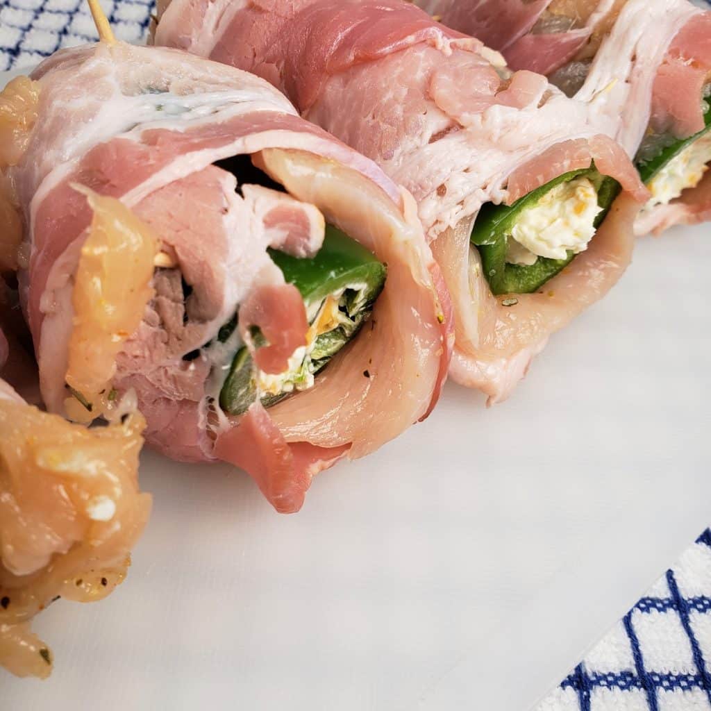 Roll Chicken and Bacon over Jalapeños